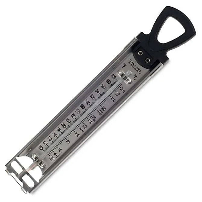 A stainless steel confection thermometer with a black pot clip on the back, displaying a scale in °F.