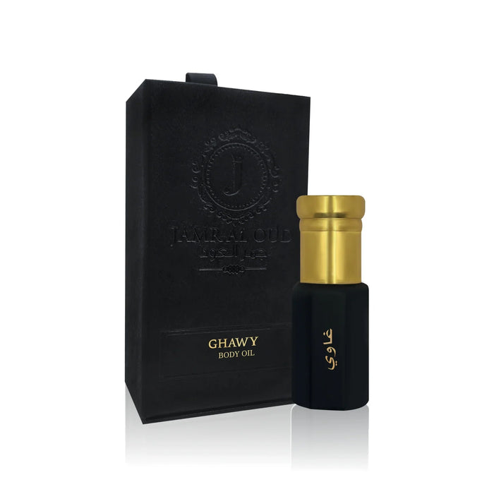 Jamr Al Oud Ghawy body oil with black and gold bottle beside branded luxury gift box