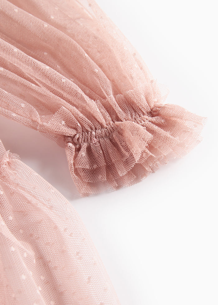 Detail image of pink tulle dress with elastic cuff and ruffles