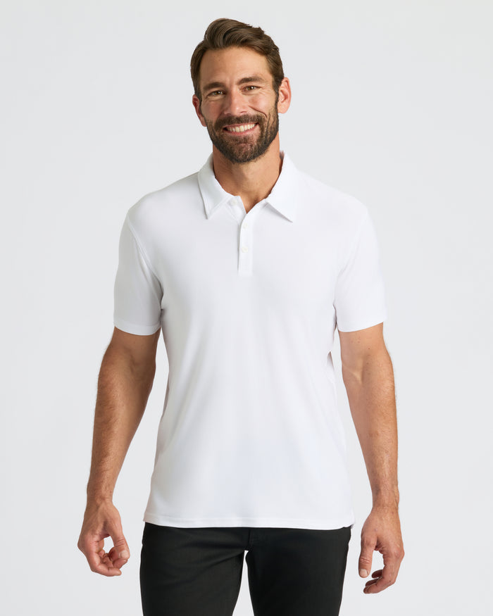 White Active Polo worn by a smiling man, showcasing its casual fit.