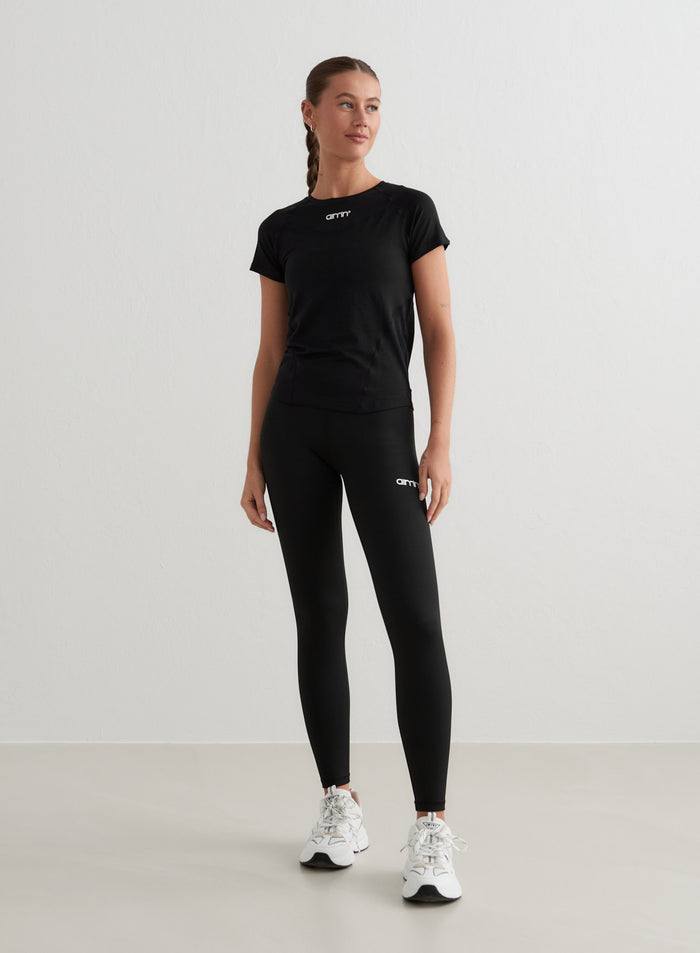 Black Soft Basic Short Sleeve tee with a second skin feel, styled with aim'n leggings and sneakers.