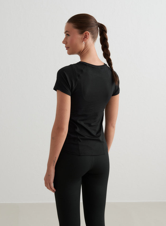 Black aim'n Soft Basic Short Sleeve workout top with a second skin feel, seen from the back.