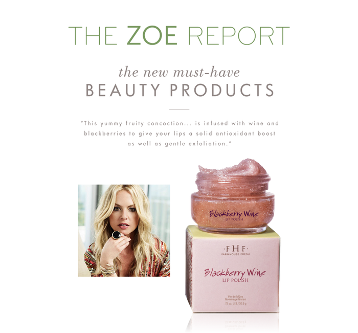 Jar of Blackberry Wine Lip Polish | Farmhouse Fresh with textured lip polish on its lid, next to its pink box packaging, alongside a woman with blonde hair wearing a floral top.