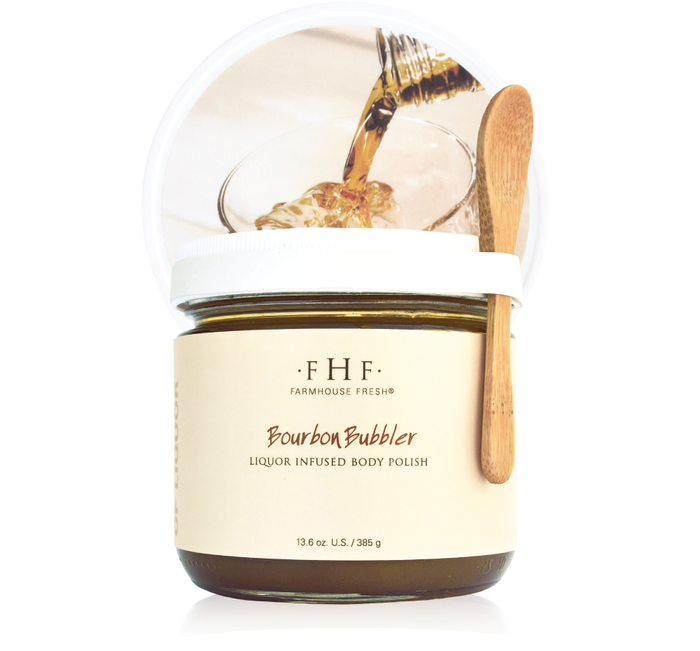 Bourbon Bubbler Liquor Infused Body Polish | Farmhouse Fresh in a glass jar with a wooden applicator spoon, featuring a label with brand and product name against a clean background.
