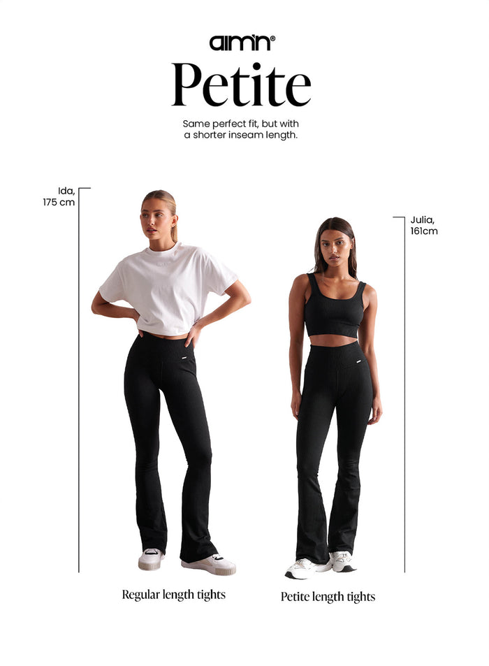 Black aim'n ribbed seamless flare tights shown in regular and petite lengths for a second skin feel.