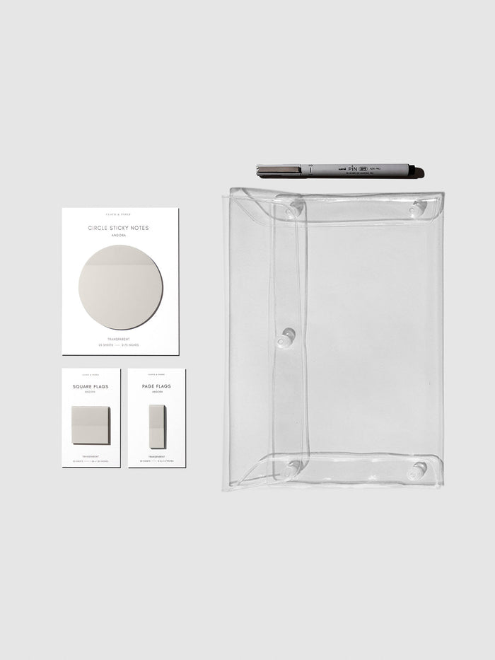 Color Bundle, Angora, Cloth & Paper. Matching set of circle sticky notes, page flags, and square page flags positioned next to a Uni Pin Marking Pen and Essentials Clear pouch. Sticky note color is Angora.