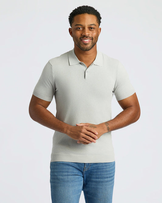 Man wearing Classic Polo and jeans, smiling with hands clasped.