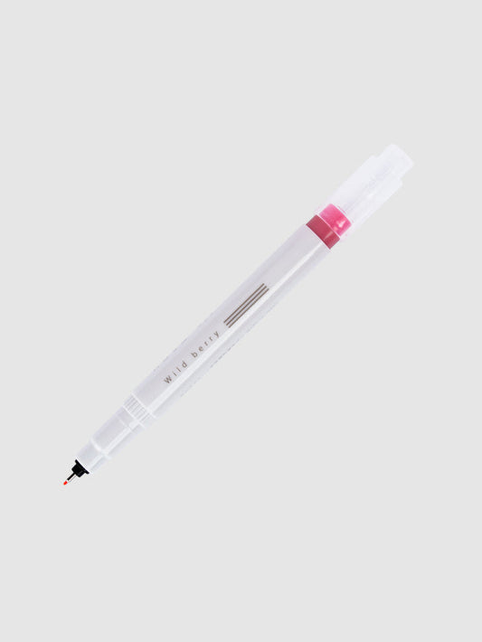 Fineliner marker in Wild Berry with nib exposed and cap posted to the end of its barrel on a neutral background.