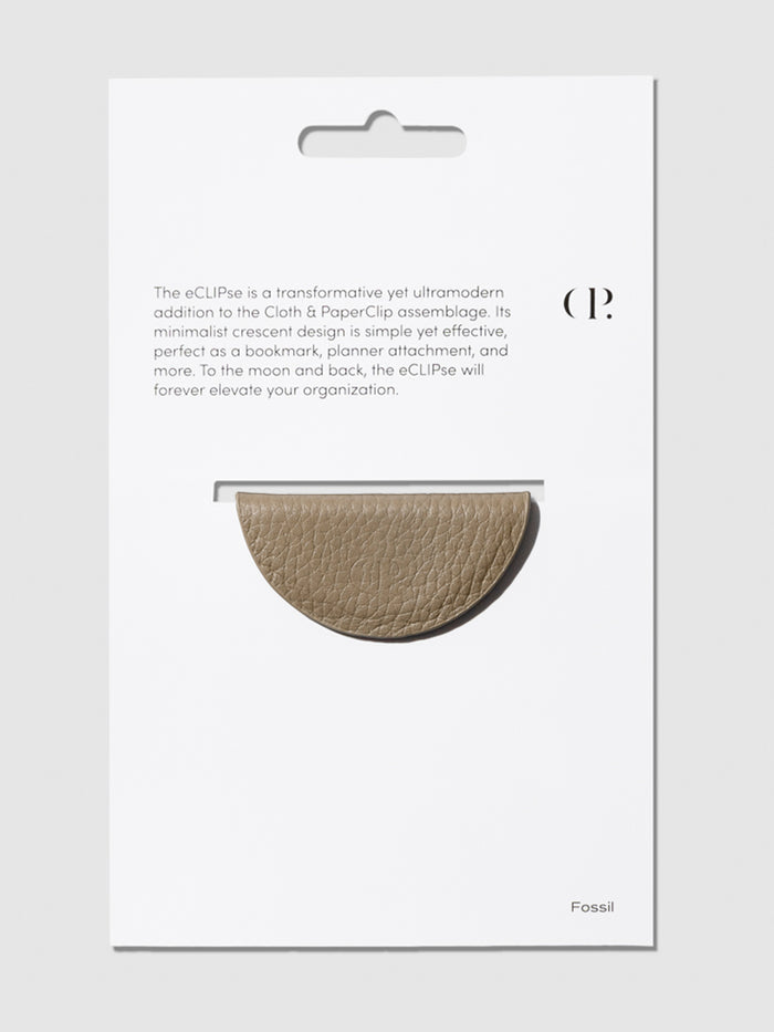 Brown bookmark shown in its packaging on a neutral background.