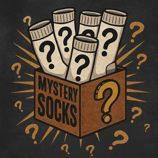 MudGear Mystery Socks illustrated in cream with question marks, emerging from brown box