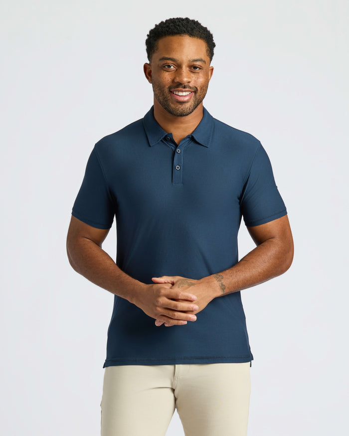 Man in Navy Active Polo 2.0 with khaki pants.