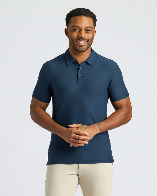 Man in Navy Active Polo 2.0 with khaki pants.