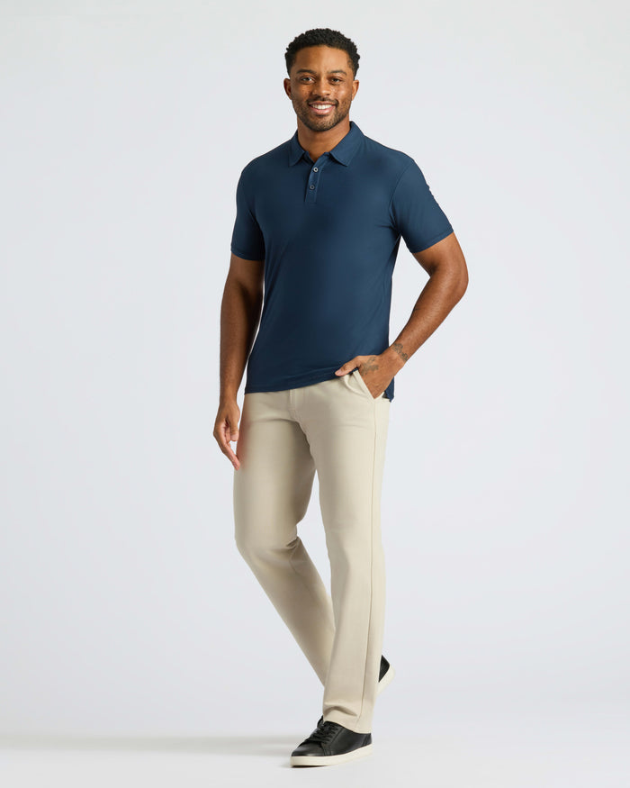 Navy Active Polo 2.0 on man with beige pants.