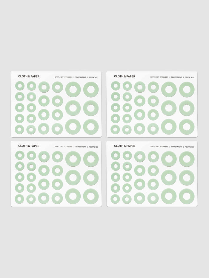 Four sheets of circular stickers of various sizes in light green, arranged on a light gray background.