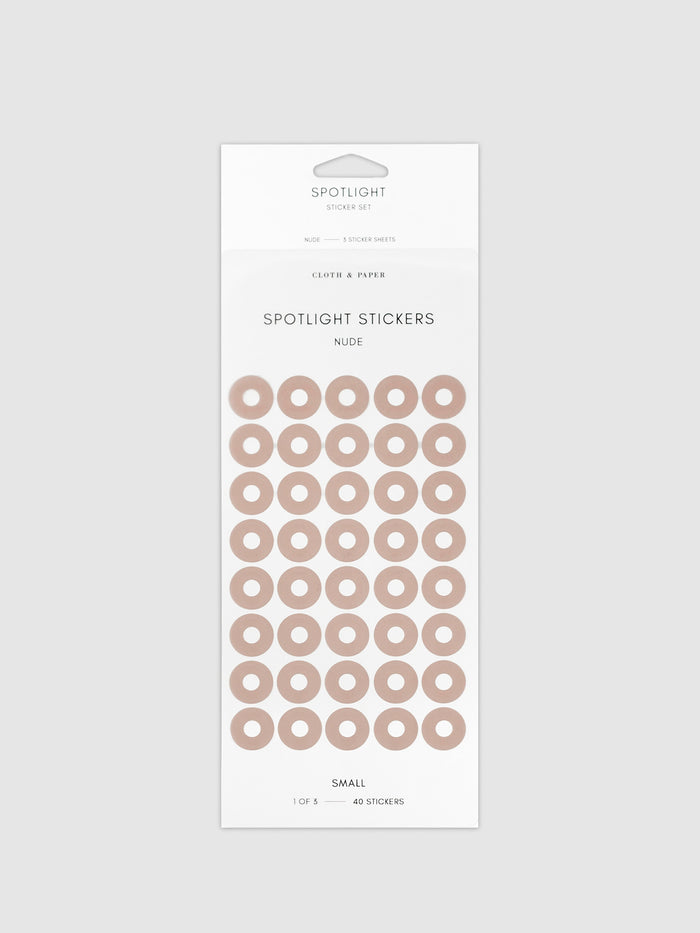 Small sticker in its packaging displayed on a neutral background. Pictured color is nude.