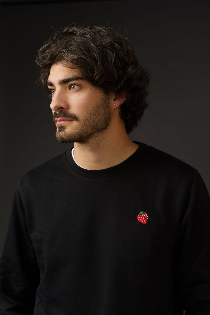 Organic cotton sweatshirt with small strawberry embroidery, minimal unisex design.