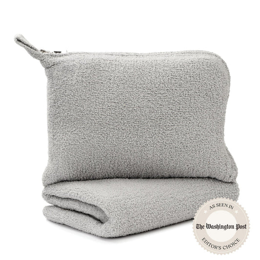 Soft gray travel blanket with plush texture, neatly folded and paired with a matching pouch, showcasing the Travel Blankets - Solid - Chenilla Fine™ | Kashwére for cozy comfort on the go.