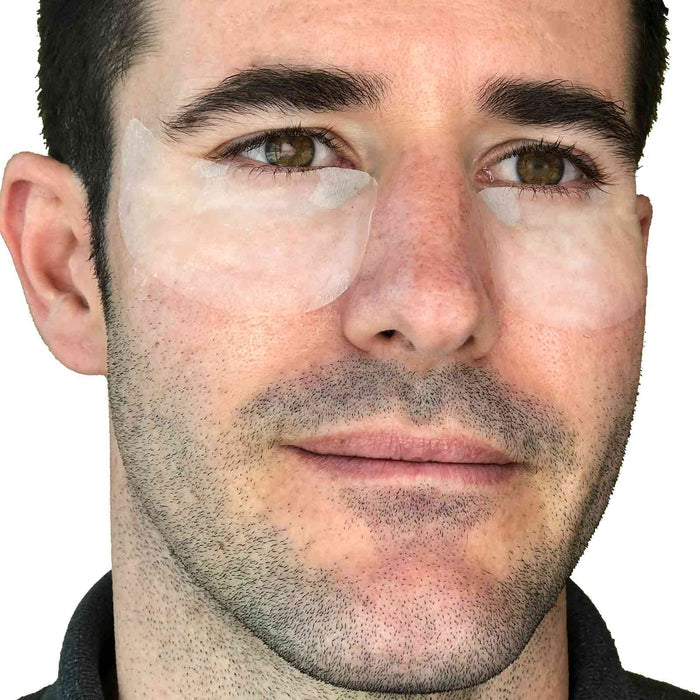 Man wearing Under Eye Rescue Mask | Skin Authority patches under both eyes as part of a skincare routine for refreshing and rejuvenating the delicate under-eye area.