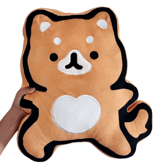 Hand holding a soft orange plush toy shaped like a fox with black and white accents, featuring a heart on its belly, called Warrior Fox Plushie | Lucky Owl.