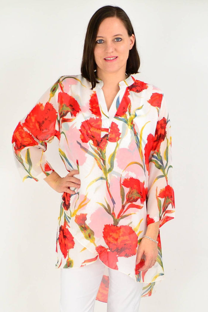 White floral button-up sleeve tunic shirt by Whispers, featuring a relaxed fit and floral pattern, displayed on a hanger.
