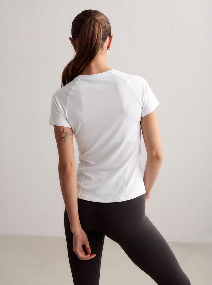 Model wearing a white aim'n Soft Basic Short Sleeve from behind [S-174 cm]